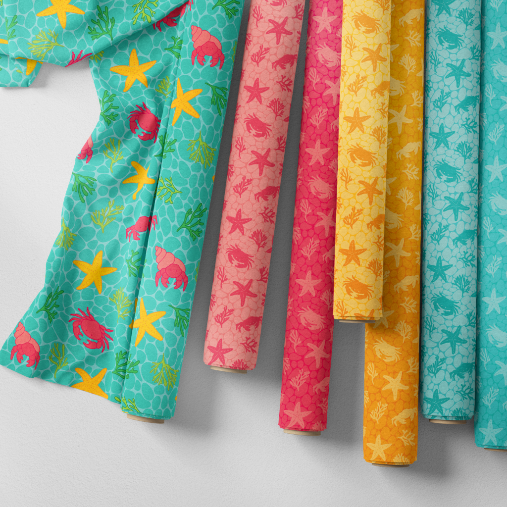 Seven rolls of Rockpool Fun fabric in watermelon red, yellow gold and aqua turquoise blue