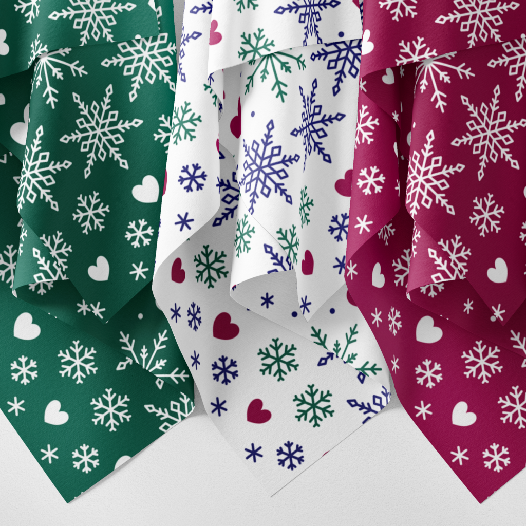 Three hanging fabrics in the Fairisle Snowflake design in green, multicolour and red