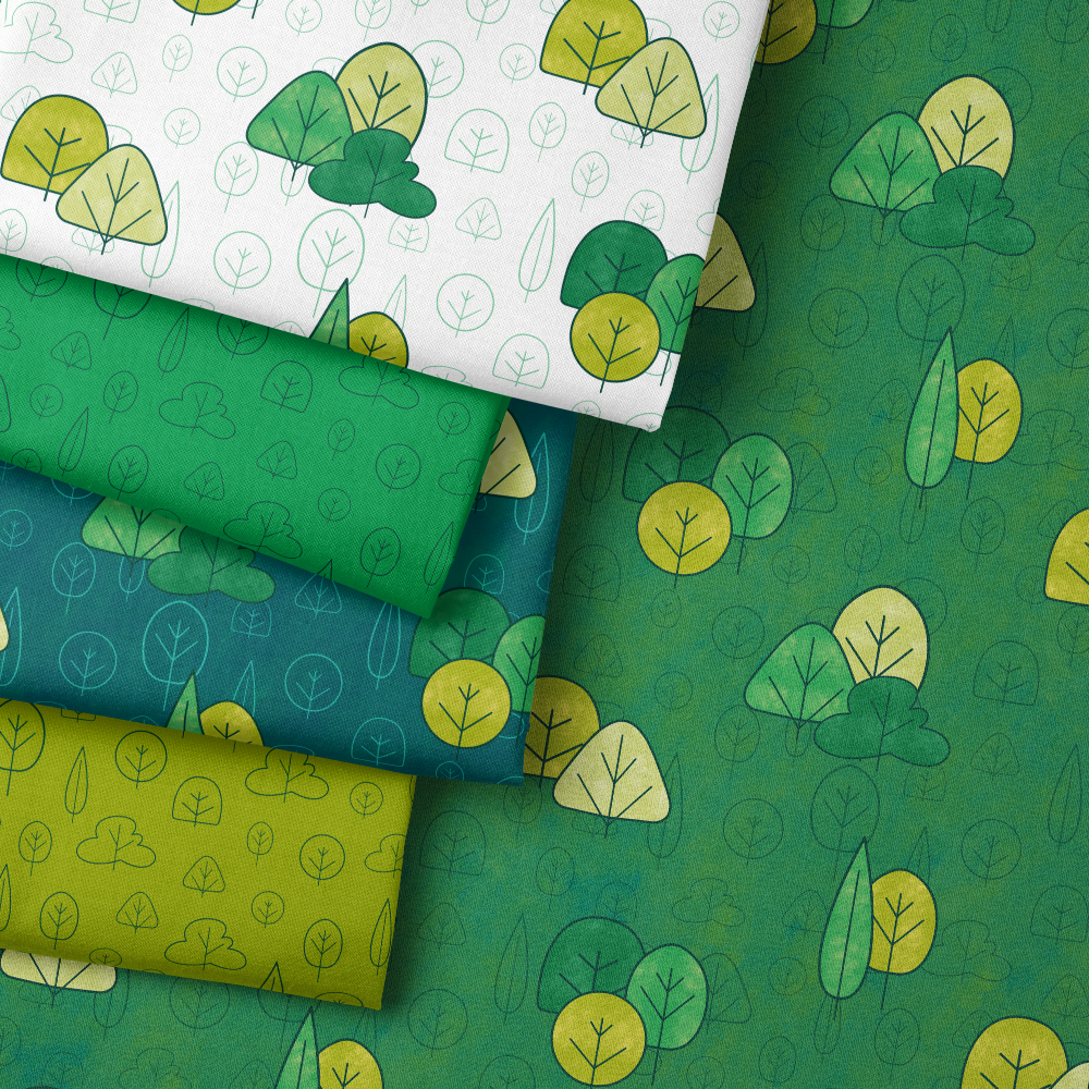 Pile of Woodland Wanders design fabric in various shades of green